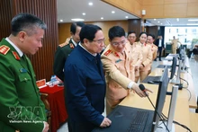 Prime Minister Pham Minh Chinh (2nd from left) sends Lunar New Year greetings to road users nationwide via a traffic application in Hanoi on February 16. (Photo: VNA)
