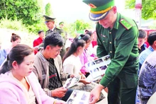 The Dien Bien Provincial Border Guard distributes leaflets promoting legal awareness to ethnic minority communities along the Viet Nam-Laos border.