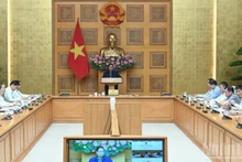 Prime Minister Pham Minh Chinh chairs an urgent meeting early on October 29 to discuss flood response and recovery efforts in the central region. (Photo: VNA)