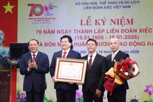On behalf of the president, Minister of Culture, Sports and Tourism Nguyen Van Hung presents the First-Class Labour Order to the Viet Nam Circus Federation.