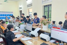 People resolve administrative procedures at the Phu Nghia Commune Public Administration Service Point.