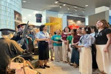 Visitors to Quang Ninh Museum experience the digital guide system in English and Vietnamese via Audio Guide. (Photo: THUAN THANH)