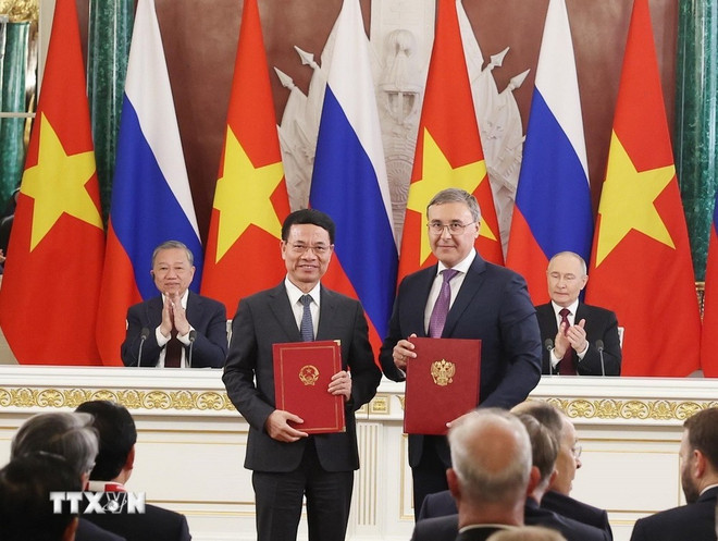 Party General Secretary To Lam and President Vladimir Putin witness the signing of an agreement between the two ministries of science and technology. (Photo: VNA)
