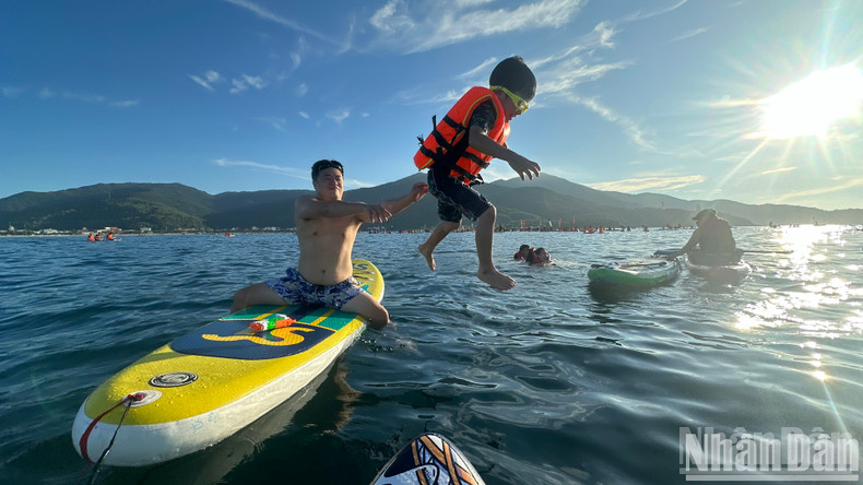 Visitors embrace the refreshing feeling of starting a new day on the water. Visitors embrace the refreshing feeling of starting a new day on the water.