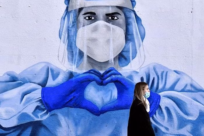 The pandemic remains a global emergency but the end could be in sight if countries use the tools at their disposal, a spokesperson for the World Health Organisation said.