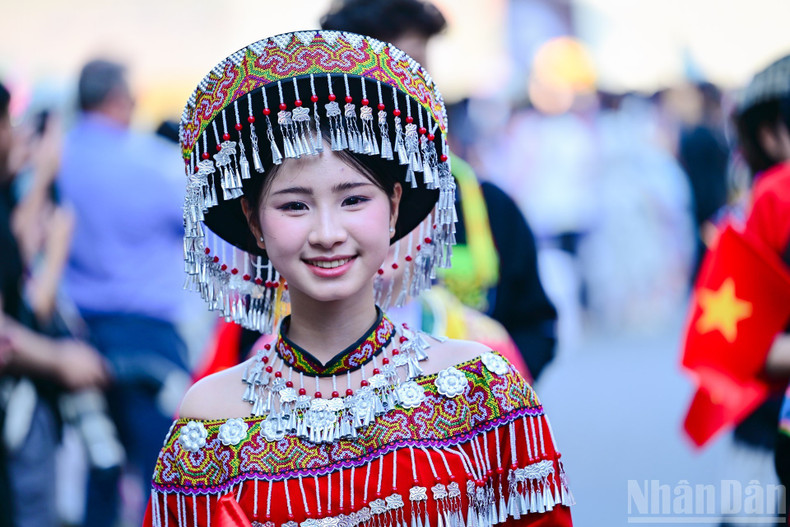 A young participant beam proudly in ethnic costume.