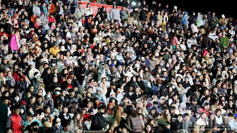Local residents and visitors attend the opening ceremony.