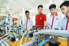 Students in an industrial electronics class practise on an automation model at Ha Noi High-Tech Vocational College.