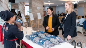 Guests visit an exhibition showcasing products from communities participating in the project.