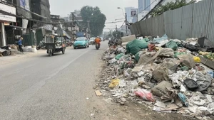 Construction waste and rubbish left untreated on La Thanh Street has generated dust and contributed to air pollution.