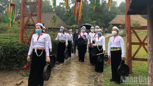 Muong people welcoming visitors at the village.