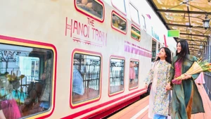 Tourists experience the ‘Ha Noi 5 Gates’ tourist train, a new tourism product in Ha Noi. (Photo: Bao Long)