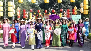 Residents of Ha Noi and visitors take part in an ao dai parade event.