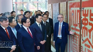 Prime Minister Pham Minh Chinh visits the exhibition space on Han Nom (classical Chinese and Vietnamese script) at the Viet Nam Academy of Social Sciences. (Photo: VNA)