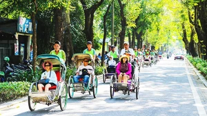 Visitors explore Hue’s green tourism by cyclo.