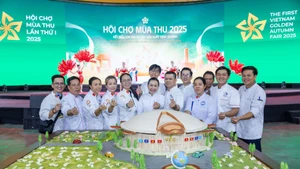 Artisans and the model of the National Exhibition and Convention Centre at the first Autumn Fair 2025.