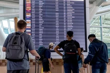 Passengers check information screens at I Gusti Ngurah Rai International Airport in Bali, Indonesia. (Photo: XINHUA)