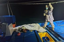 A survivor (L) rests aboard a boat on waters off Kedah, Malaysia, Nov. 9, 2025. At least one individual has been found dead and six have been rescued after a boat carrying nearly 100 undocumented migrants sank in waters near the Malaysia-Thailand maritime border, local police said on Sunday, according to Malaysia's national news agency Bernama. (Malaysian Maritime Enforcement Agency/Handout via Xinhua)