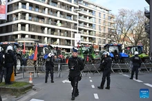 Police officers secure a road as farmers park tractors during a protest near the Europa Building in Brussels, Belgium, Dec. 18, 2025. Thousands of farmers from across Europe rallied near the European Parliament and the Europa Building in Brussels on Thursday as European Union (EU) leaders convened for a summit, with a long-negotiated trade deal with the South American bloc Mercosur on the agenda. (Photo: Xinhua)