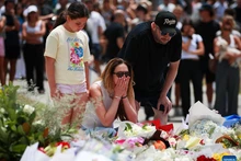 People mourn the victims of the Bondi Beach shooting in Sydney, Australia, Dec. 15, 2025. The death toll from a shooting at Sydney's Bondi Beach on Sunday has risen to 16, with a father and son identified as the attackers, police said Monday. (Photo: Xinhua)