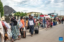 Displaced people from the Democratic Republic of the Congo (DRC) are seen in the town of Bugarama in neighboring Rwanda, on Dec. 5, 2025. The March 23 Movement (M23) rebels have expanded their operations across several areas of South Kivu Province in eastern Democratic Republic of the Congo (DRC) over the past days, even as the DRC and Rwanda signed in Washington a peace deal hailed as a major step toward de-escalation in the region. Residents in the affected areas reported a FARDC pullback and the displacement of civilians fleeing the new combat zones. Hundreds of families have arrived in Uvira, while others from Kamanyola, a strategic crossroad in the province, crossed into Rwanda to escape shellfire. (Photo: Xinhua)
