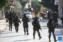 Israeli soldiers are seen during a military operation in the West Bank city of Qalqilya, Dec. 4, 2025. Israeli forces expanded their military campaign in the northern West Bank on Thursday, imposing a tight cordon on the Kafr Saba neighborhood in Qalqilya and restricting Palestinian movement in the area. (Photo: Xinhua)