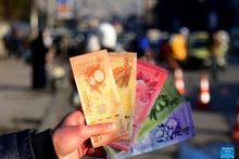 A Syrian citizen shows newly issued Syrian pound banknotes at a designated exchange point in Damascus, Syria, Jan. 4, 2026. Syria has begun circulating its new currency following a nationwide exchange process launched earlier this month. (Photo: Xinhua)