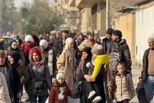 This photo taken with a mobile phone shows civilians leaving areas in the Sheikh Maqsoud and Ashrafieh neighborhoods in Aleppo city, northern Syria, on Jan. 7, 2026. Crowds of residents were forced to flee the predominantly Kurdish neighborhoods of Sheikh Maqsoud and Ashrafieh in the northern city of Aleppo on Wednesday, as clashes flared between the Syrian army and the Kurdish-led Syrian Democratic Forces (SDF). (Str/Xinhua)