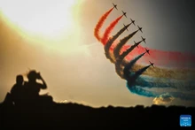 People watch an aircraft performance on the Malta International Airshow at St. Paul's Bay in Malta, Sept. 28, 2025. Since its inception in 1993, the bi-annual event organized by the Malta Aviation Society has attracted aviation enthusiasts from around the world to celebrate their shared passion for flight. (Photo: Xinhua)