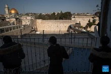 People pray facing the Western Wall from an elevated platform, in Jerusalem's Old City, March 5, 2026. Israeli police tighten security across Jerusalem's Old City, closing the Western Wall and its plaza amid persisting regional tensions. (Photo: Xinhua)
