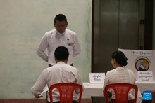 A voter checks in at a polling station in Yangon, Myanmar, Dec. 28, 2025. Myanmar kicked off its 2025 multi-party democratic general election with the first phase held on Sunday. The general election is scheduled to be held in three phases, with the second phase set for Jan. 11, 2026, followed by the third phase on Jan. 25. (Photo: Xinhua)