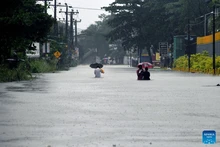 People wade through a flooded street after heavy rains in Colombo, Sri Lanka, Nov. 28, 2025. Sri Lanka's Disaster Management Center (DMC) said on Saturday that the death toll from Cyclone Ditwah, which has been affecting the country in recent days, has climbed to 123, with 130 people still missing. (Photo: Xinhua)