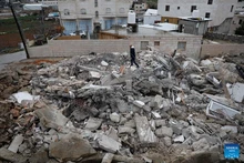 A Palestinian checks the rubble of a house demolished by the Israeli forces in the city of Hebron, southern West Bank, on Jan. 15, 2026. Israeli authorities arrested 80 Palestinians, demolished a house, and barred the Palestinian Authority's minister of Jerusalem affairs from entering the West Bank, according to Palestinian sources on Thursday. (Photo: Xinhua)