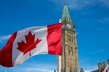 The Canadian flag flies over Parliament Hill in Ottawa. (Photo: Government of Canada)