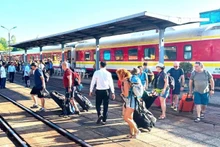 Tourists aboard the high-quality JQB1 train as it arrives at Dong Hoi Station.