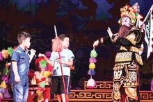 Children from the “Reading Books with Children” Club experience tuong (classical drama) stage props. (Photo: Reading Books with Children Club)