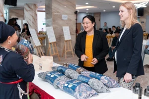Guests visit an exhibition showcasing products from communities participating in the project.