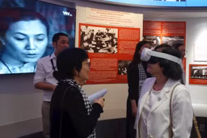 Delegates explore a digital interactive exhibition space at the War Remnants Museum.