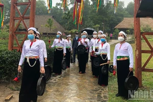 Muong people welcoming visitors at the village.