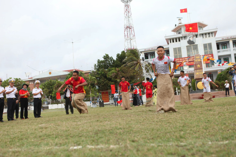 People participate in a sack race competition.
