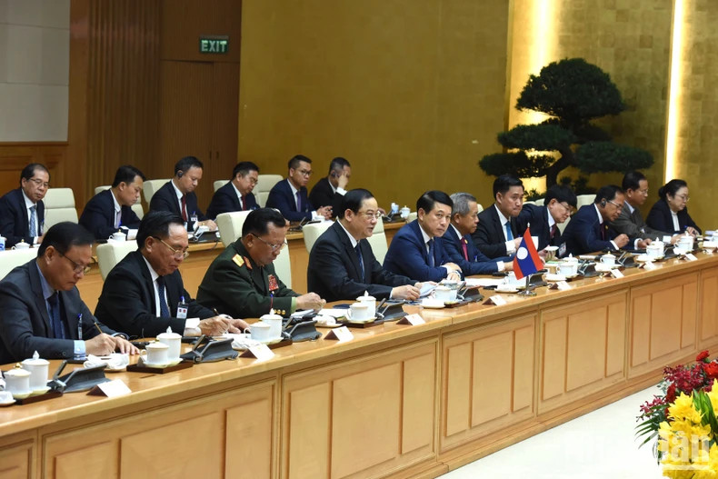 Lao Prime Minister Sonexay Siphandone and members of the Lao government at the talks.