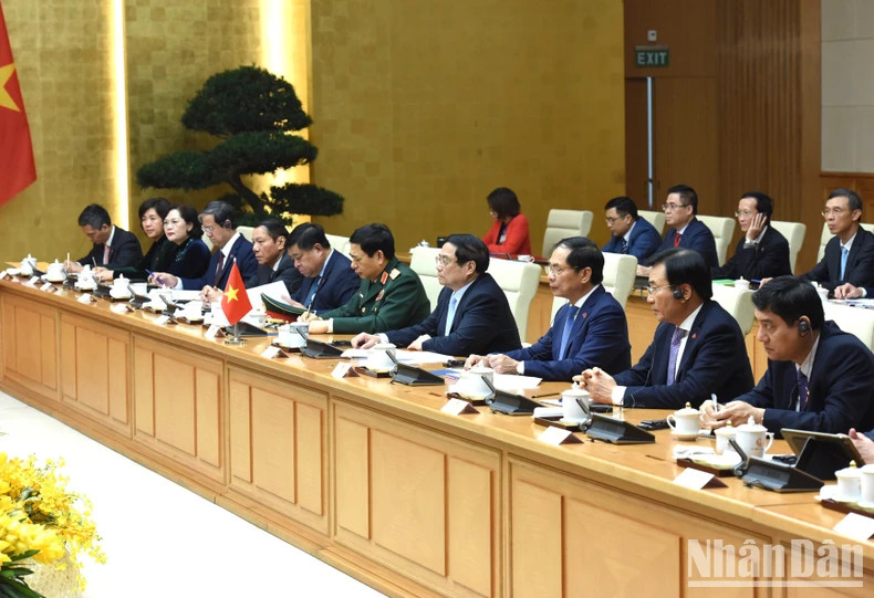 Prime Minister Pham Minh Chinh and members of the Vietnamese government at the talks.