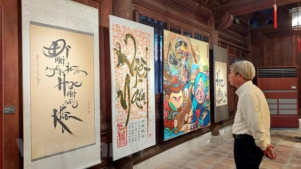 A visitor admiring artworks on display at the exhibition (Photo: VNA)