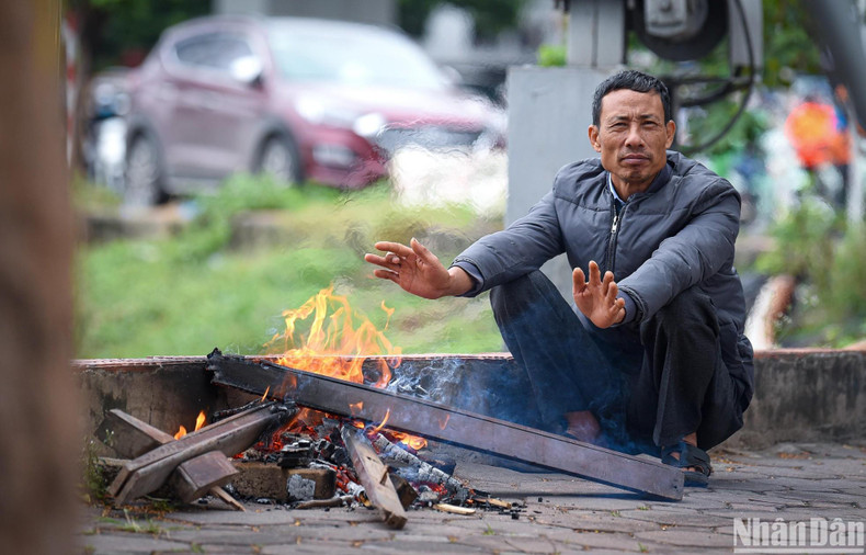 A man-made wood fire to stay warm amid the chilly wind. A man-made wood fire to stay warm amid the chilly wind.