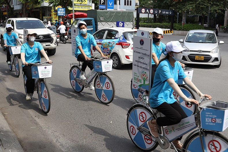 Delegates join a bicycle parade to inform the public of the health impact of smoking
