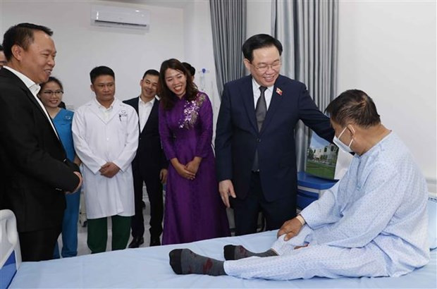 NA Chairman Vuong Dinh Hue visits a patient at the hospital. (Photo: VNA)