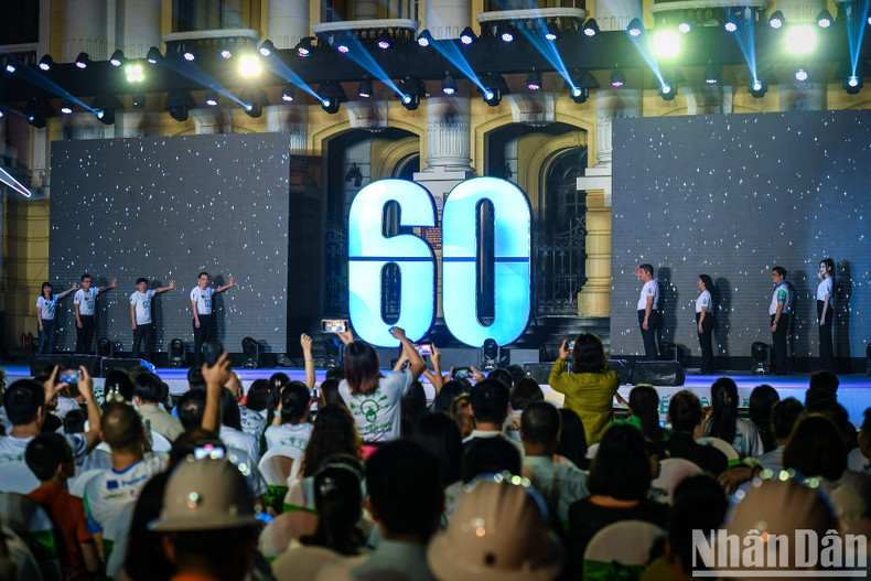 Delegates perform the symbolic gesture of turning off the lights, in response to the Earth Hour campaign.