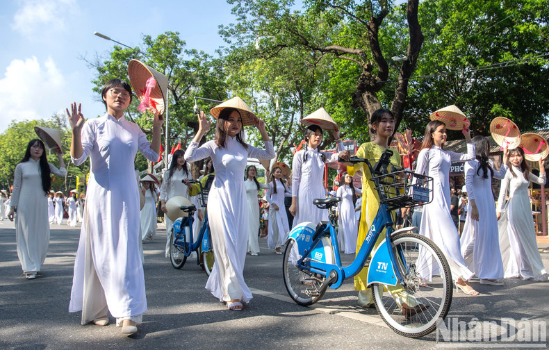 A parade of young women in white Ao dai. A parade of young women in white Ao dai.