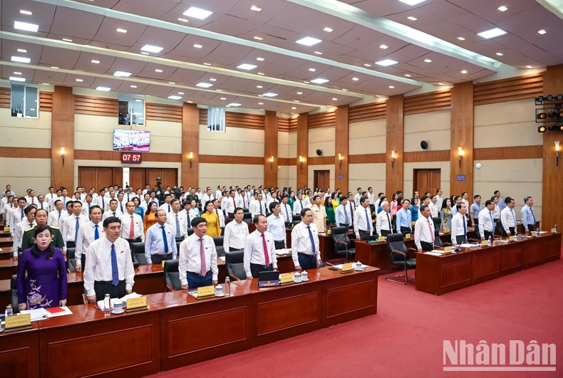 Delegates perform the flag-raising ceremony at the opening ceremony.