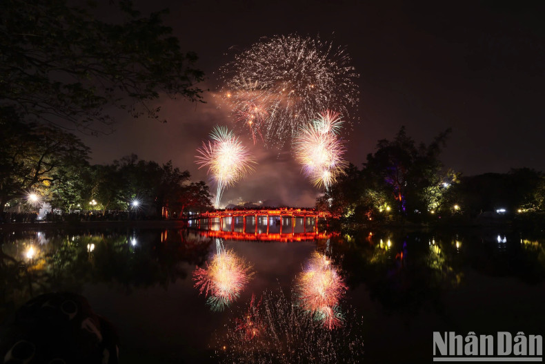 Fireworks illuminate the sky above The Huc Bridge. Fireworks illuminate the sky above The Huc Bridge.